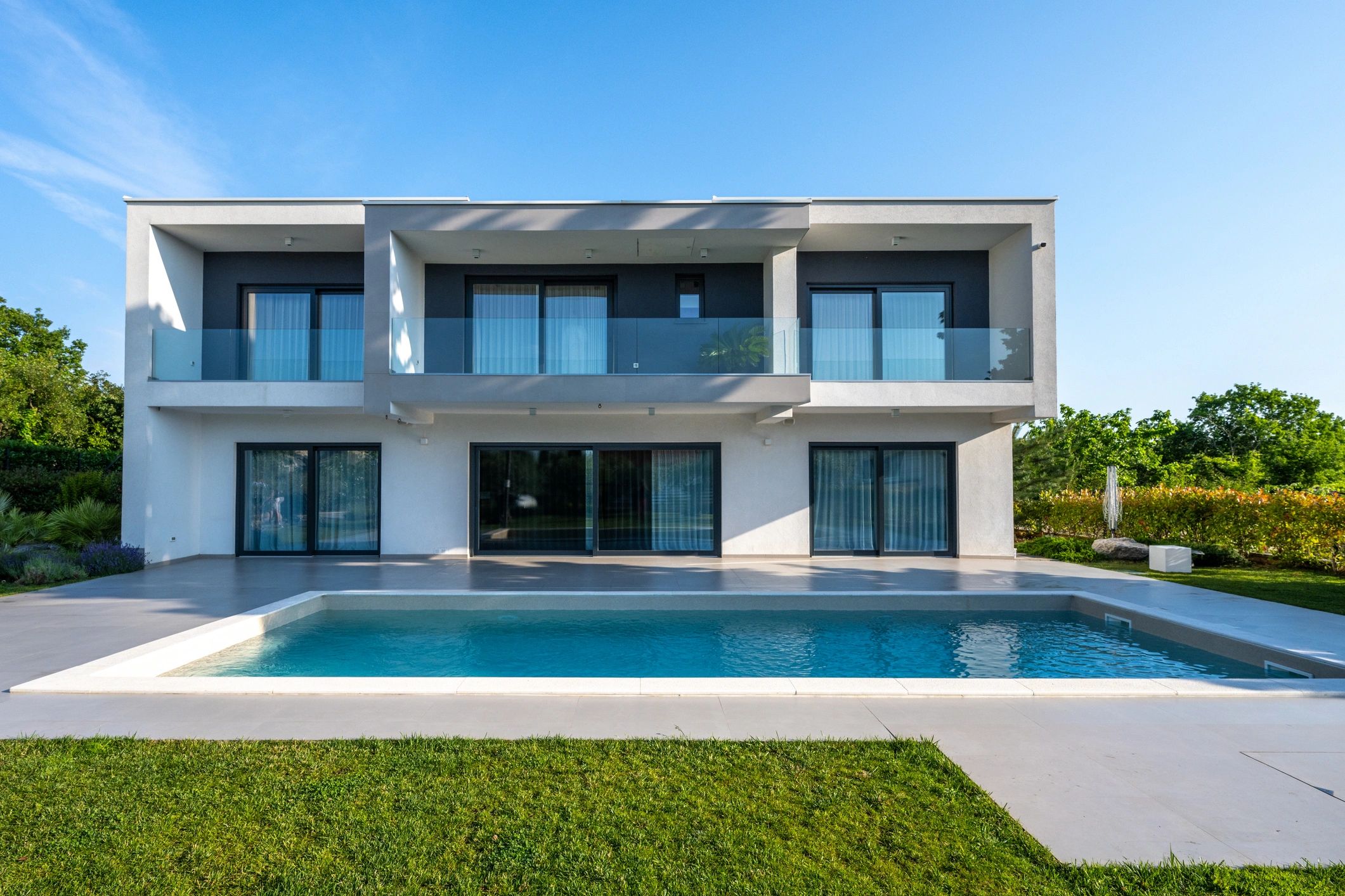 Modern luxury home exterior with pool