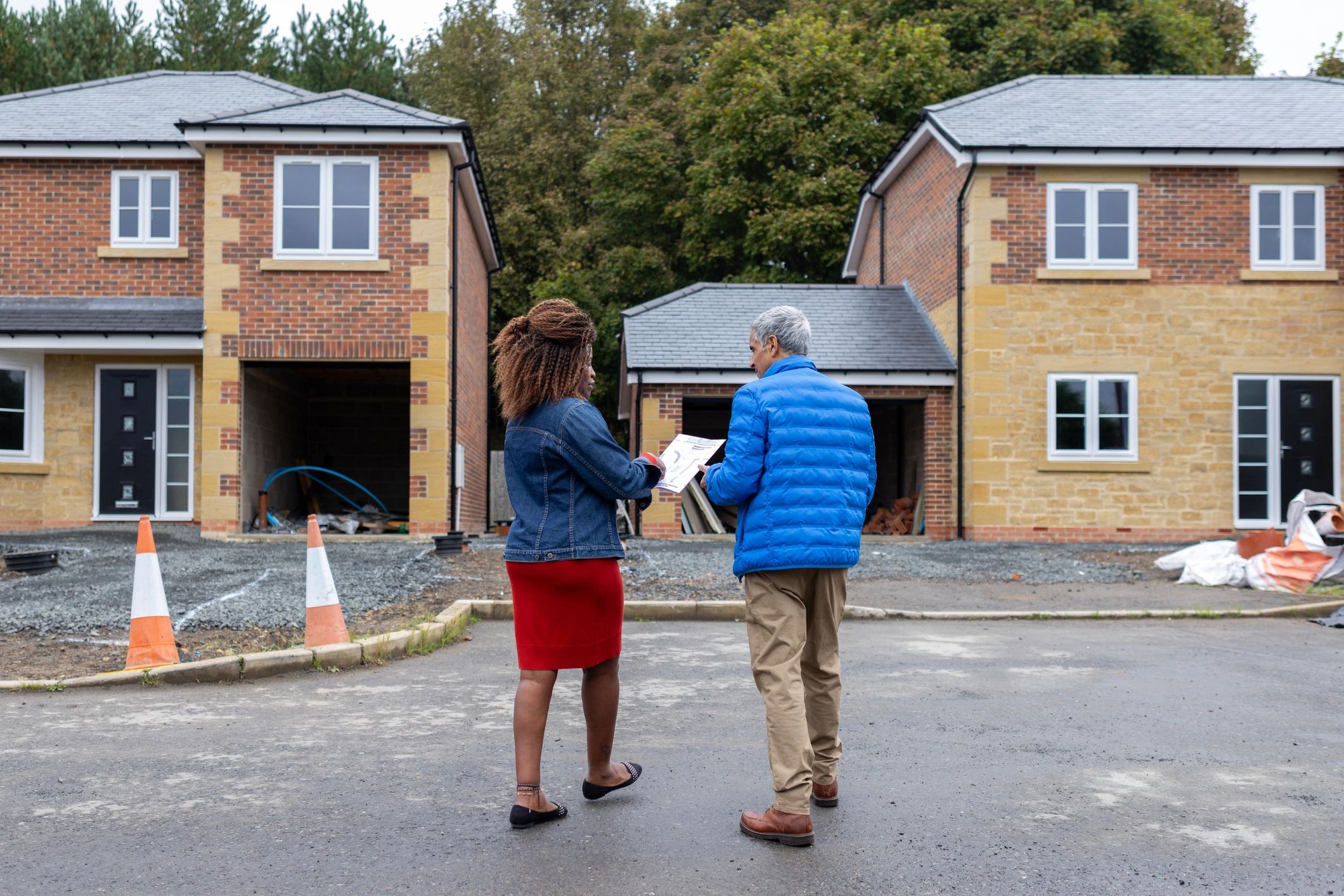 Real estate advisor discussing property plans with a buyer